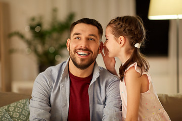 Image showing happy daughter whispering secret to father at home