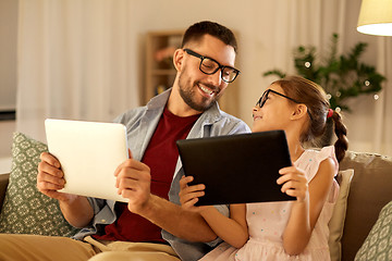 Image showing father and daughter with tablet computers at home