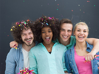 Image showing confetti party multiethnic group of people isolated over gray