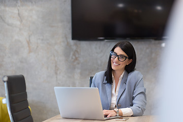 Image showing businesswoman using a laptop in startup office