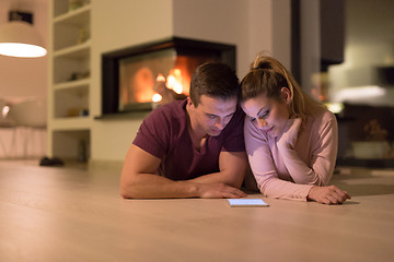 Image showing Young Couple using digital tablet on cold winter night