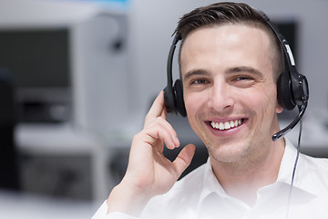 Image showing male call centre operator doing his job