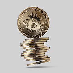 Image showing Bitcoin is a gold coin and a stack of crypto-currencies