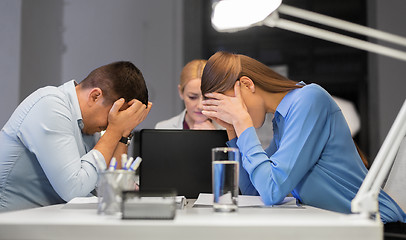 Image showing business team with laptop working late at office