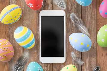 Image showing smartphone with easter eggs and quail feathers