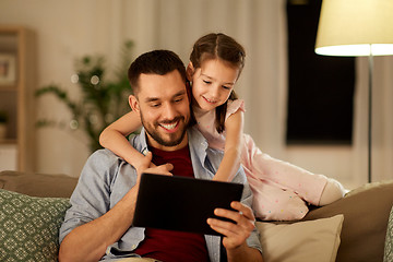 Image showing father and daughter with tablet computer at home