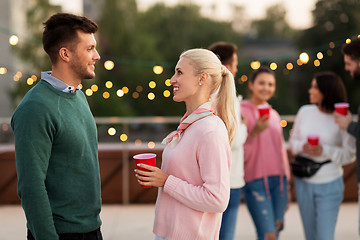 Image showing friends with drinks in party cups at rooftop