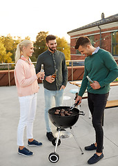 Image showing happy friends having bbq party on rooftop