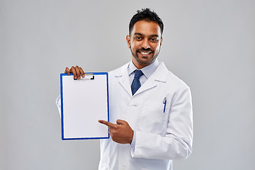 Image showing doctor or scientist with white paper on clipboard