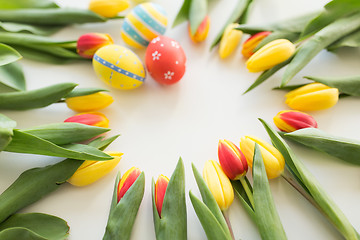 Image showing close up of colored easter eggs and tulip flowers