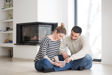 Image showing Young Couple using digital tablet on cold winter day