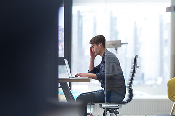 Image showing businessman working using a laptop in startup office