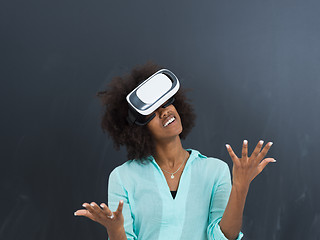 Image showing black girl using VR headset isolated on gray background