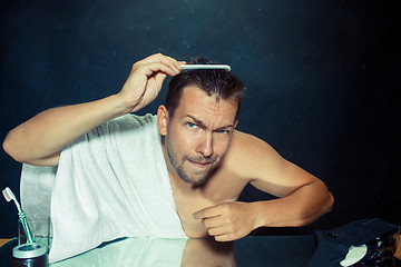 Image showing Man With Comb Concerned About Hair Loss