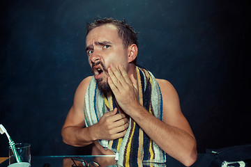 Image showing Close up photo of young man looking for acnes on his face