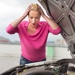 Image showing Stressed Young Woman with Car Defect.