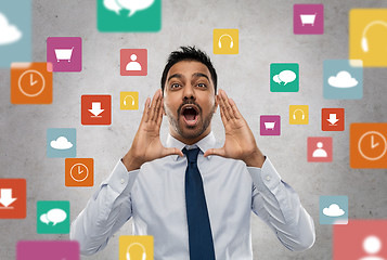 Image showing indian businessman shouting over app icons