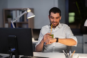 Image showing happy businessman with smart watch at nigh office