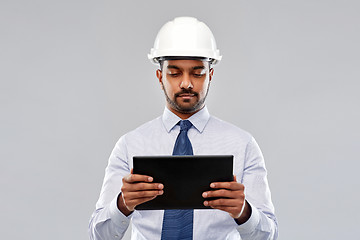 Image showing architect or businessman in helmet with tablet pc