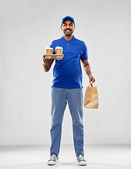 Image showing happy indian delivery man with food and drinks