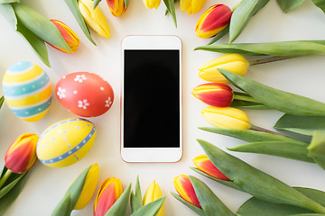 Image showing smartphone with easter eggs and tulip flowers