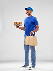 Image showing happy indian delivery man with food and drinks