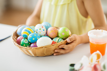 Image showing close up of girl with easter eggs in wicker basket