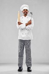 Image showing happy indian chef with ladle and rolling-pin