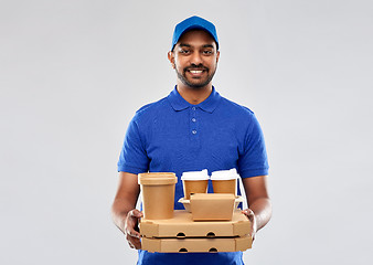 Image showing happy indian delivery man with food and drinks