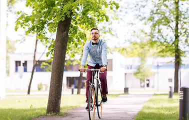 Image showing happy young hipster man riding fixed gear bike