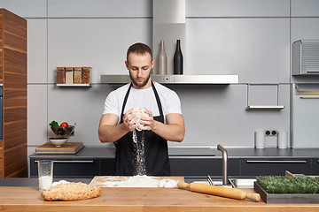 Image showing Man mixing dough in the kitchen