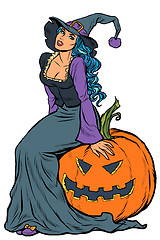 Image showing Halloween witch sitting on a pumpkin