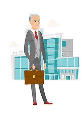 Image showing Senior caucasian businessman holding briefcase.