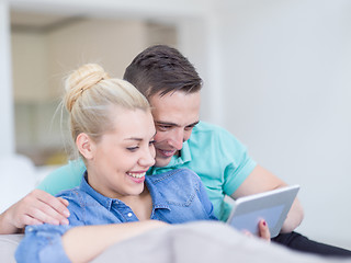 Image showing couple relaxing at  home with tablet computers