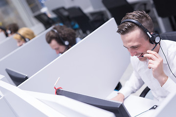 Image showing male call centre operator doing his job