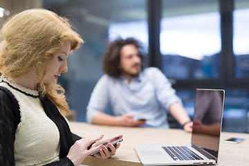 Image showing Elegant Woman Using Mobile Phone in startup office building