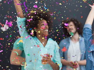 Image showing confetti party multiethnic group of people isolated over gray