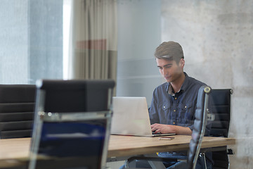 Image showing businessman working using a laptop in startup office