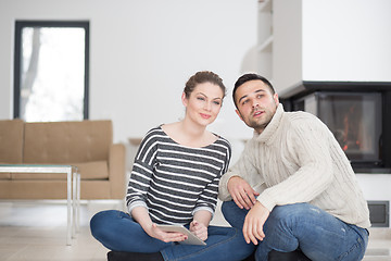 Image showing Young Couple using digital tablet on cold winter day