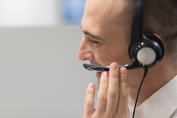 Image showing male call centre operator doing his job