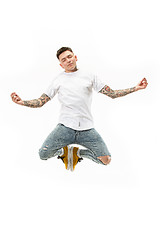 Image showing Yoga in moving. handsome young man jumping against white background