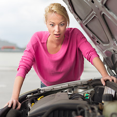Image showing Stressed Young Woman with Car Defect.