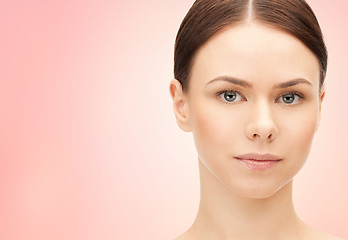 Image showing face of beautiful woman over pink background