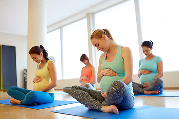 Image showing happy pregnant women exercising at gym yoga