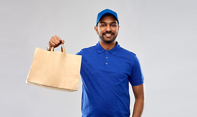 Image showing happy indian delivery man with food in paper bag