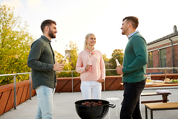 Image showing happy friends having bbq party on rooftop