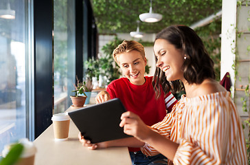 Image showing female friends with tablet pc and coffee at cafe