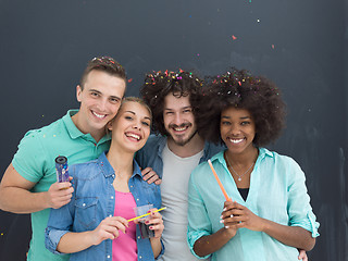 Image showing confetti party multiethnic group of people isolated over gray