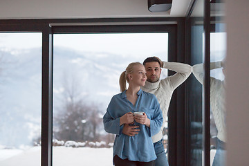 Image showing young couple enjoying evening tea by the window