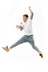 Image showing Jumping fan on white background. The young man as soccer football fan with megaphone